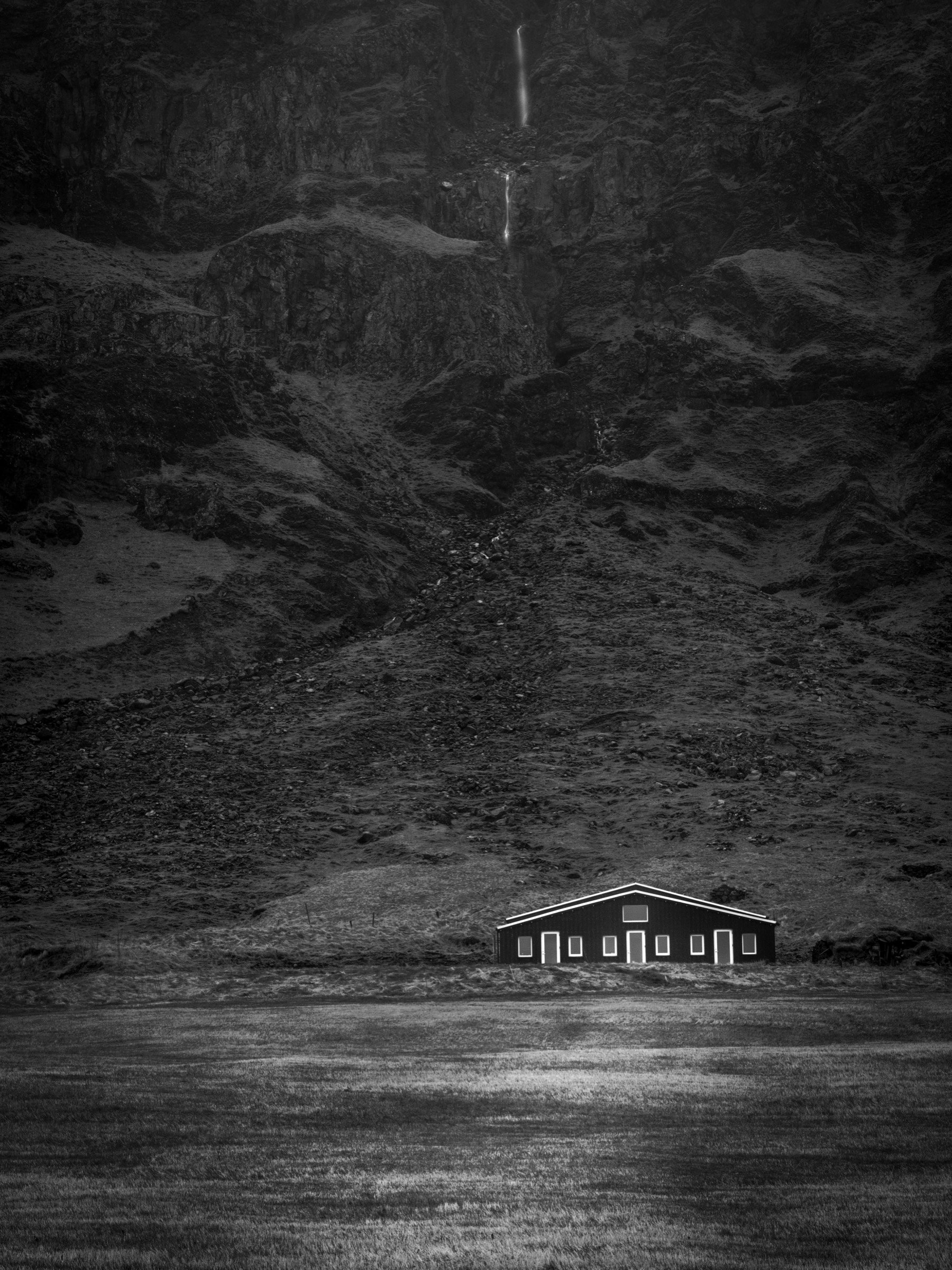Lone house beneath the cliff